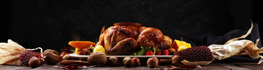 Baked turkey or chicken. The Christmas table is served with a turkey, decorated with fruits, salad...