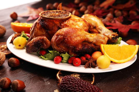Baked turkey or chicken. The Christmas table is served with a turkey, decorated with fruits, salad and nuts. Fried chicken, table. Christmas dinner
