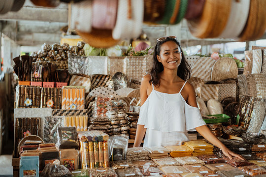 Asian Woman With Tanned Skin In The Souvenir Shop 