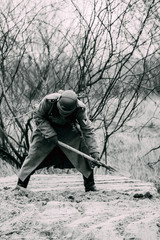 Fototapeta na wymiar German Wehrmacht soldier digging trench