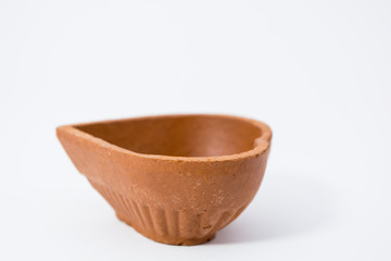 Closeup of Diwali terracotta diyas on Isolated white background.