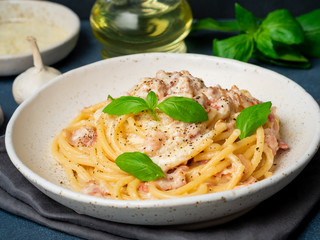 Carbonara pasta, spaghetti with pancetta, egg, parmesan cheese, cream sauce. Traditional italian cuisine. Side view, close up