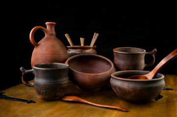 Set of antique pottery on wooden background