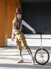 Pretty young lady in a fantasy clothes with unicycle © Alexey Kuznetsov