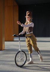 Pretty young woman in a fantasy clothes with unicycle © Alexey Kuznetsov