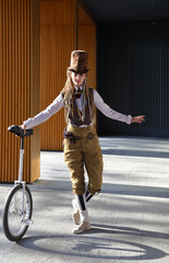 Pretty girl in a fantasy clothes and make-up with unicycle © Alexey Kuznetsov