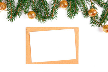 Festive flat lay composition with blank invitation for new year celebration and craft paper envelope. Christmas greeting card template concept. Background, copy space, top view.