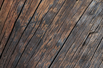 Dark brown rough wood texture background with scratches and cracks on surface