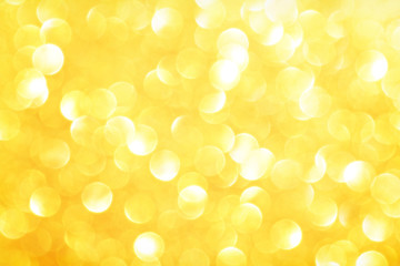 Golden sparkle glitters with bokeh effect and selectieve focus. Festive background with bright gold...