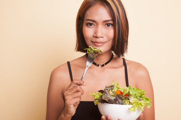 Healthy Asian woman with salad.