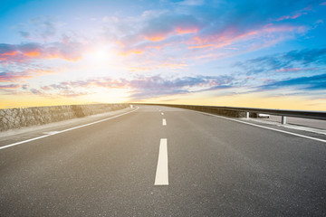 Empty highway asphalt pavement and sky cloud landscape..