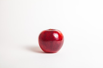 ripe shiny red apple on white background