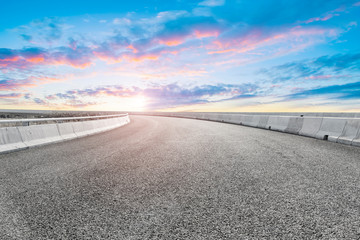 Empty highway asphalt pavement and sky cloud landscape..