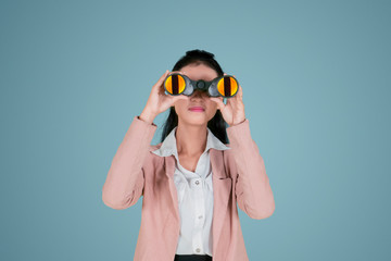 Female entrepreneur looking at through binoculars