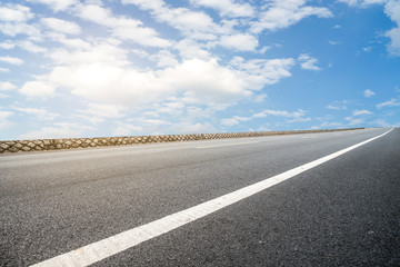 Empty highway asphalt pavement and sky cloud landscape..