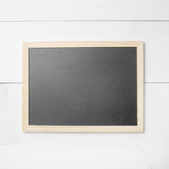 Small empty chalkboard on wooden texture