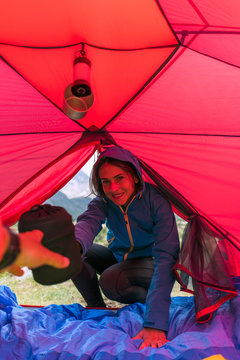 Female hiker setting up for camping