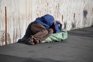 A homeless man sleeps on a street in downtown Mexico-City. 