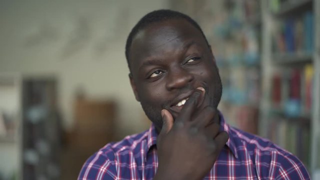 African american male is thinking looking in camera
