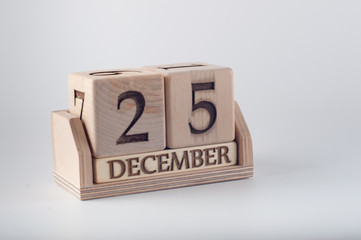 Calendar with Christmas date made of wooden cubes and planks