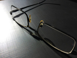 glasses on a dark background, shadow of the rim, metallic material