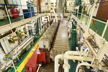 Panoramic view of main engine on a merchant ship in the engine room