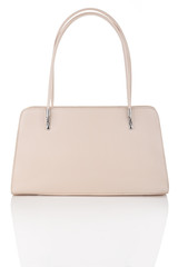 Beige handbag isolated on white with reflection