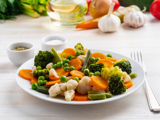 Mix of boiled vegetables, steam vegetables for dietary low-calorie diet. Broccoli, carrots, cauliflower, side view