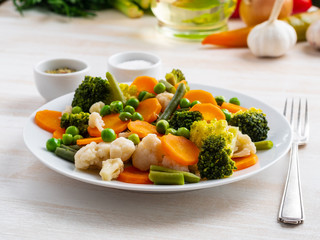 Mix of boiled vegetables, steam vegetables for dietary low-calorie diet. Broccoli, carrots, cauliflower, side view