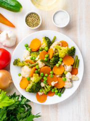 Mix of boiled vegetables, steam vegetables for dietary low-calorie diet. Broccoli, carrots, cauliflower, top view, vertical