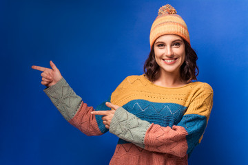 smiling girl in knitted sweater and yellow hat 