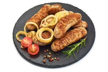 Grilled Munich sausages with fried onion, herbs and tomatoes, isolated on a white background. Close-up