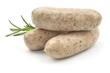 Raw Nuremberg Sausages with herbs, isolated on a white background. Close-up.