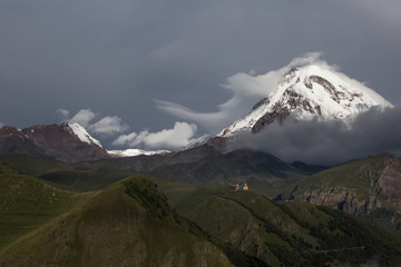Fototapeta premium Beautiful panorama view on Kazbek peak mount from the Stepantsminda village in the summer