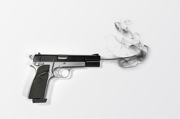 A semi-automatic 9mm smoking hand gun over bright white background with plenty of negative space for copy.