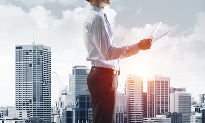 Concept of business success and control with confident boss against cityscape background