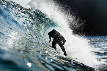 A surfer riding a heavy wave