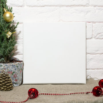 Square blank canvas in interior. Mock up poster. Christmas and New Year concept.