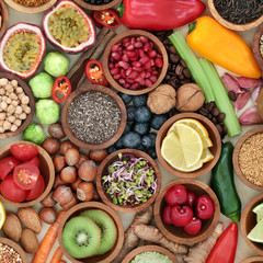 Health food for fitness  concept with fresh fruit, vegetables, grains, nuts, seeds, coffee, herbs and spices. High in antioxidants, anthocyanins, vitamins and dietary fibre.