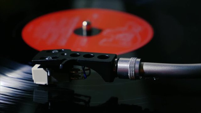 Closeup needle on spinning vintage vinyl record on turntable