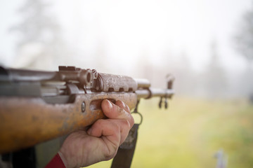Man hands and Russian machine gun fire closeup