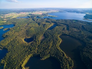 Aerial view of beautiful landscape of Mazury region - Krzywa Kuta Lake, Goldopiwo Lake in the distance, Poland - obrazy, fototapety, plakaty