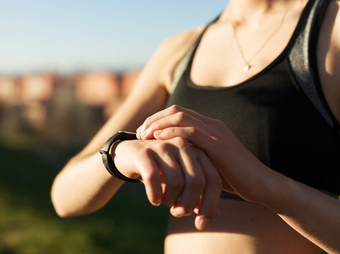 Crop woman using smartwatch