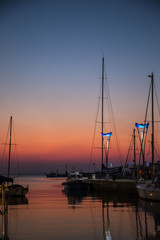 Yachts in marina at sunset