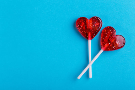 Naklejka Two red sweet tasty lollipops in shape of heart