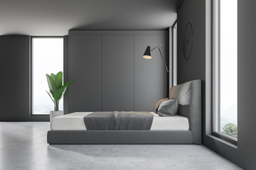 Side view of gray bedroom with clock