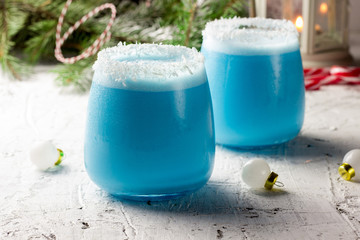 Blue curacao Christmas Cocktail on Christmas decorated holiday table © juliamikhaylova