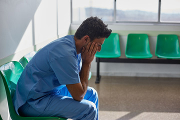Doctor resting alone in a hospital waiting room.
