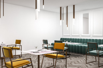 White cafe corner green sofa yellow chairs