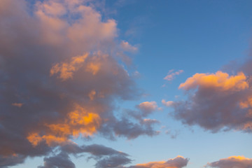 Beautiful dramatic sky. Sunset orange clouds. Orange golden sunset. Sunset rays of the sun over the sea through the clouds skyward. Sunset natural composition